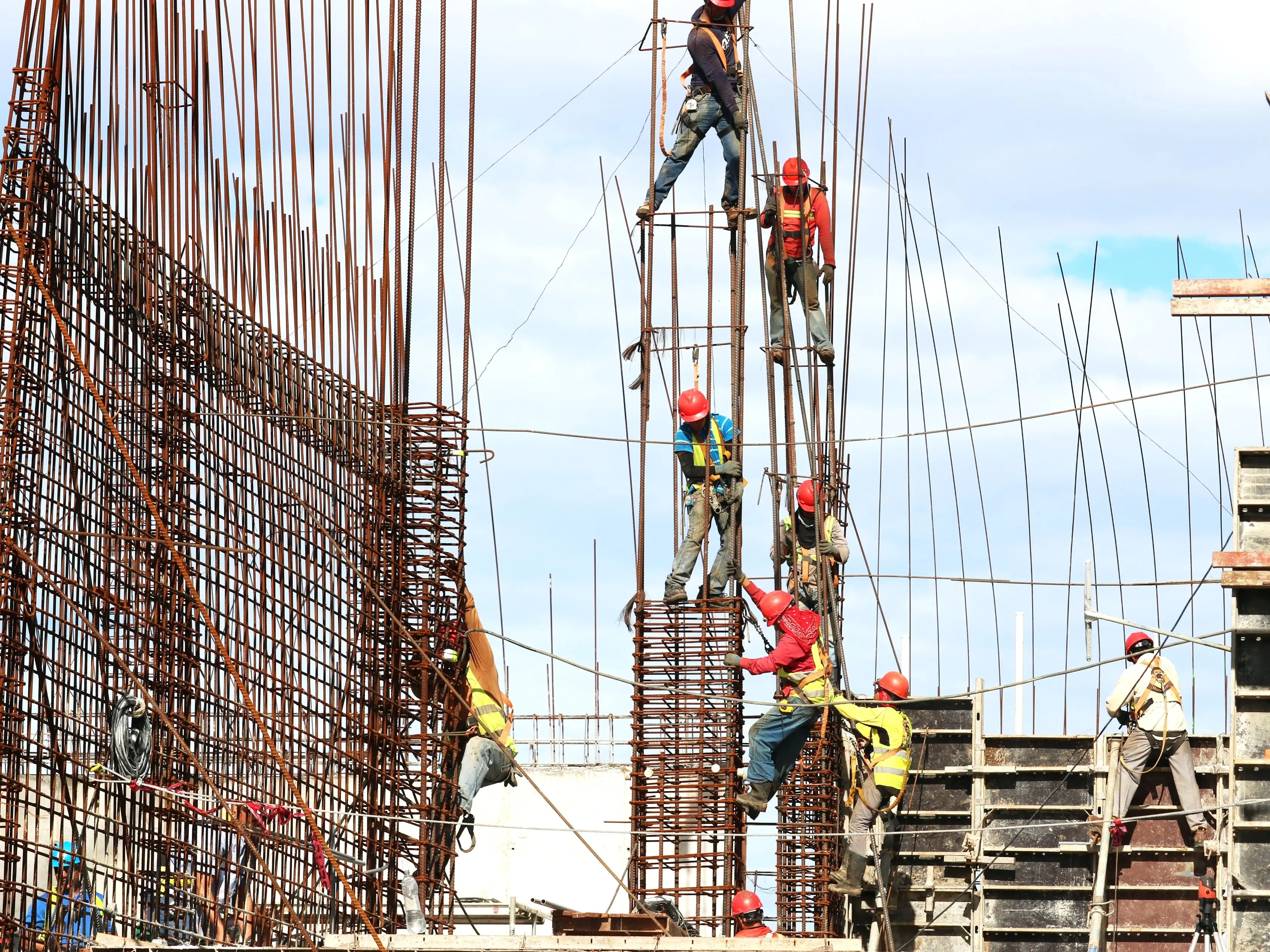 People working on building during daytime.