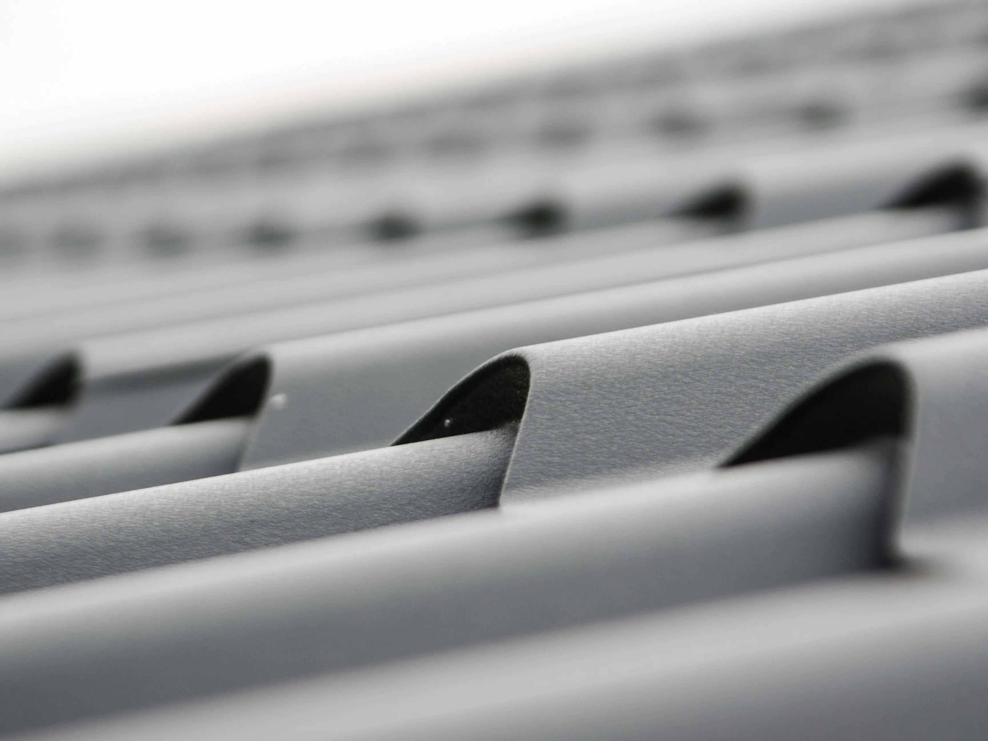 Stacked gray steel sheets.